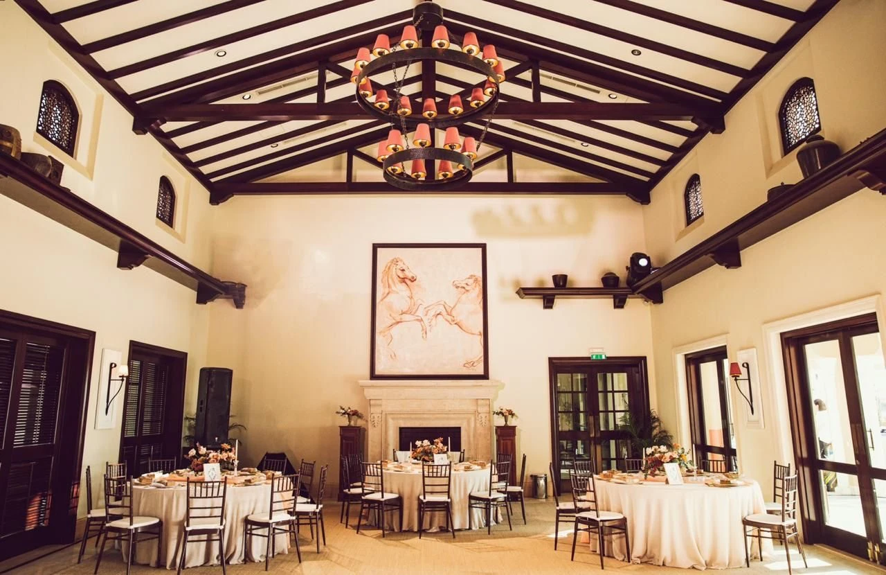 Elegant event space with round tables at Dubai Polo & Equestrian Club, Dubai, UAE.