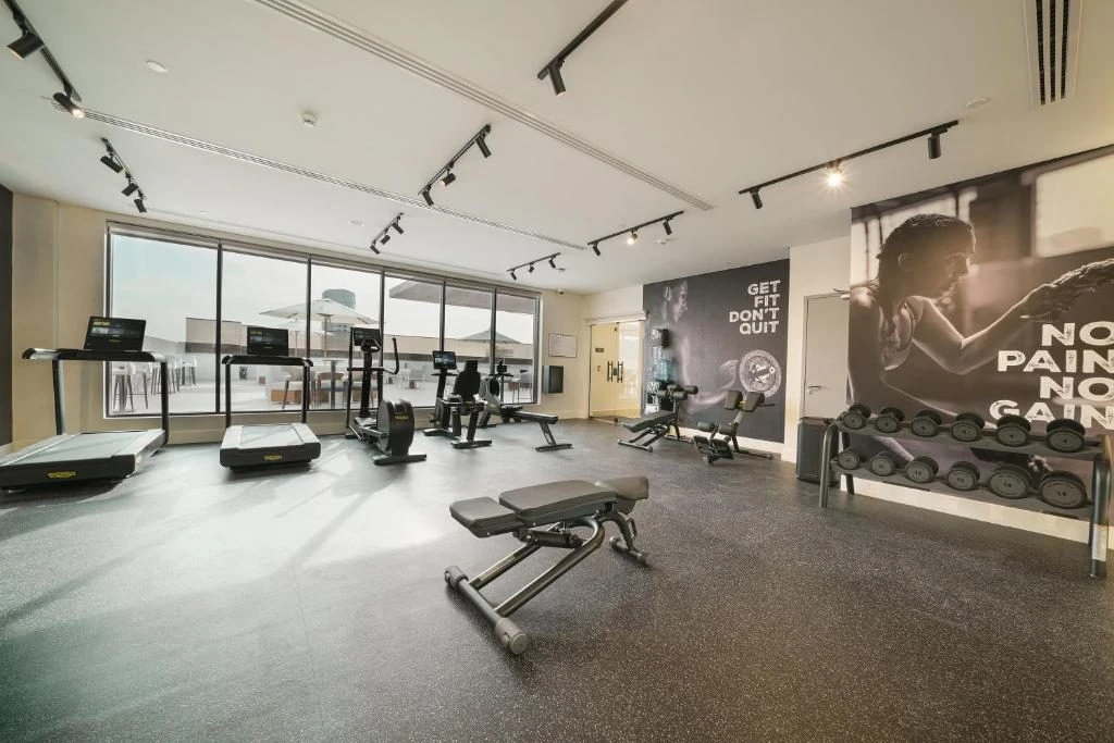Modern gym with treadmills and weights at Nova M Hotel Riyadh Edge by Rotana.