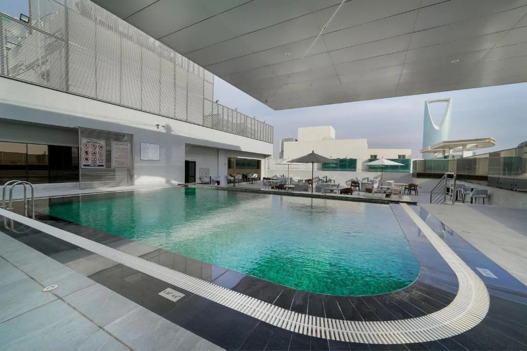 Outdoor pool and seating area at Nova M Hotel Riyadh Edge by Rotana.