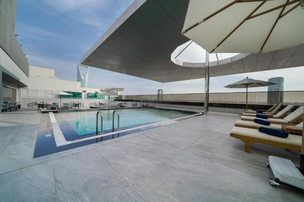 Rooftop pool area with loungers at Nova M Hotel Riyadh Edge by Rotana.