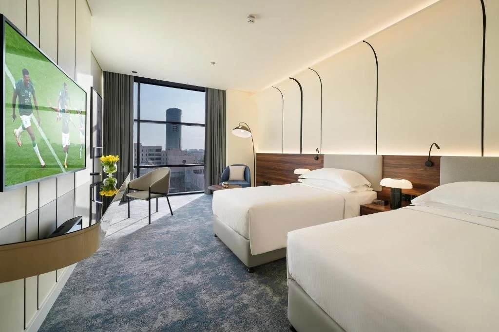 Modern guest room with twin beds at Nova M Hotel Riyadh Edge by Rotana.