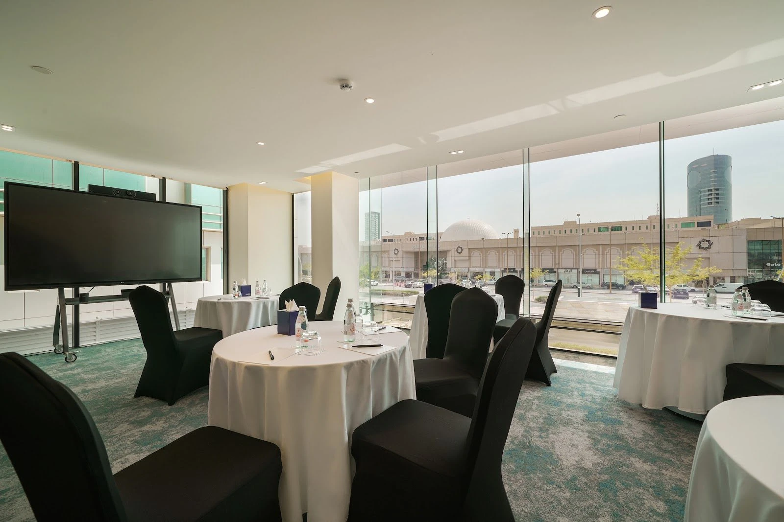 Conference room with round tables at Nova M Hotel Riyadh Edge by Rotana.