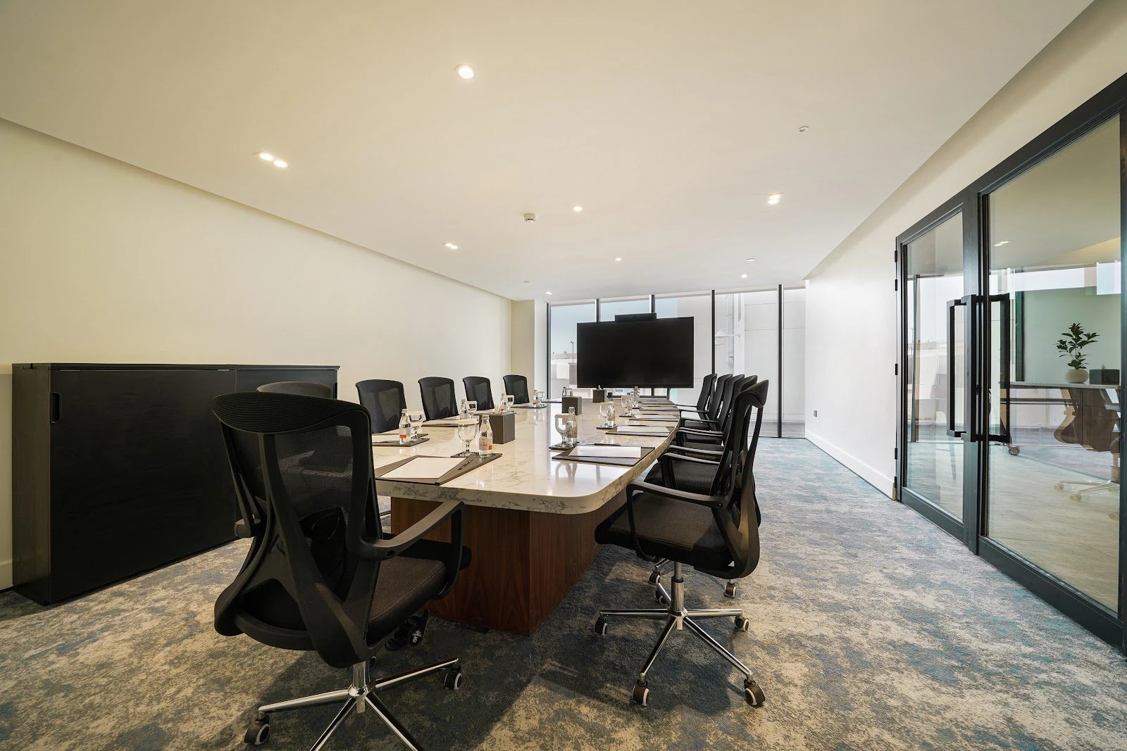 Conference room with long table and chairs at Nova M Hotel Riyadh Edge.