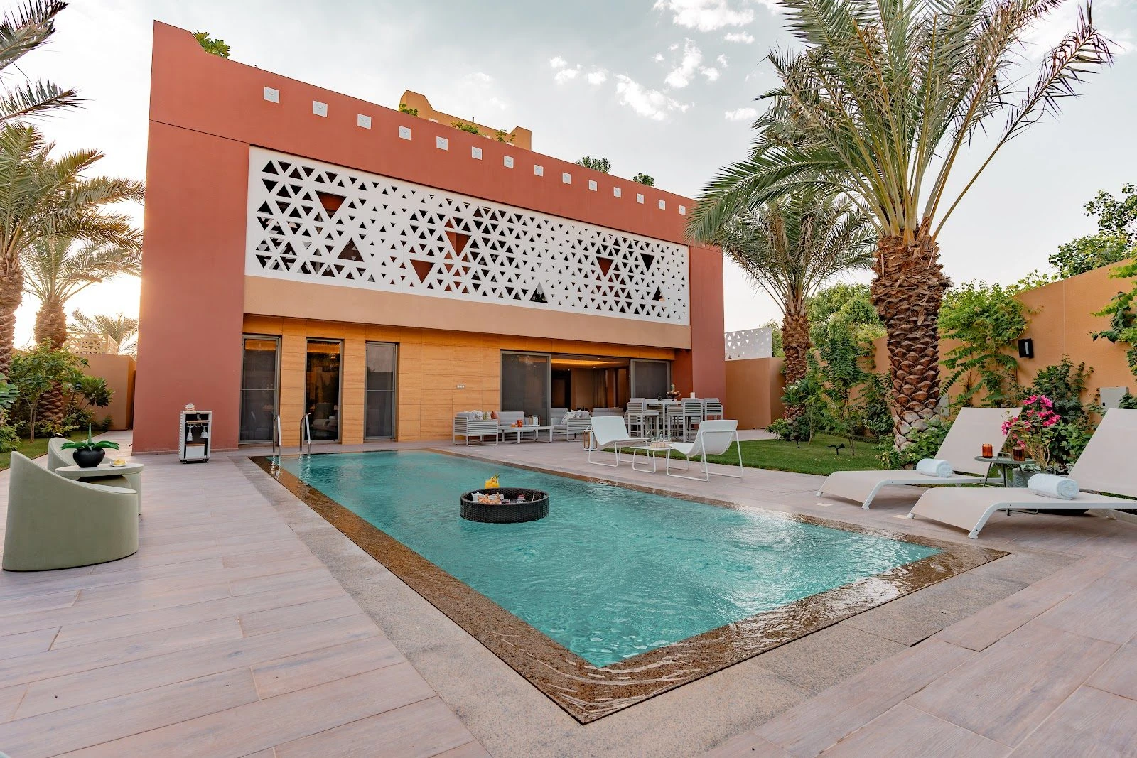 Outdoor pool area with palm trees at Vivienda Riyadh Diplomatic Quarter, Riyadh, KSA.