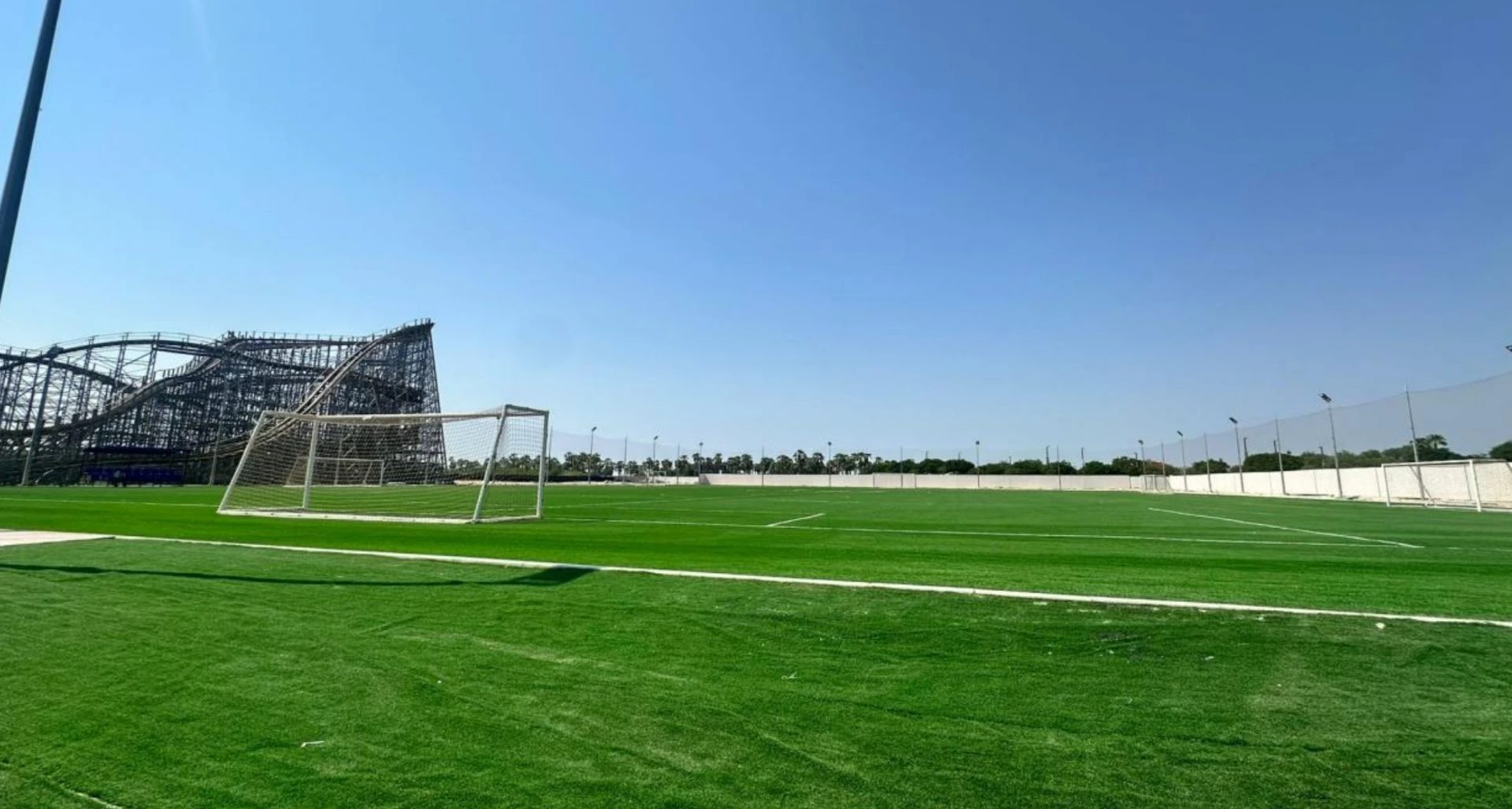 Soccer field and roller coaster at Dubai Parks and Resorts, Dubai, UAE