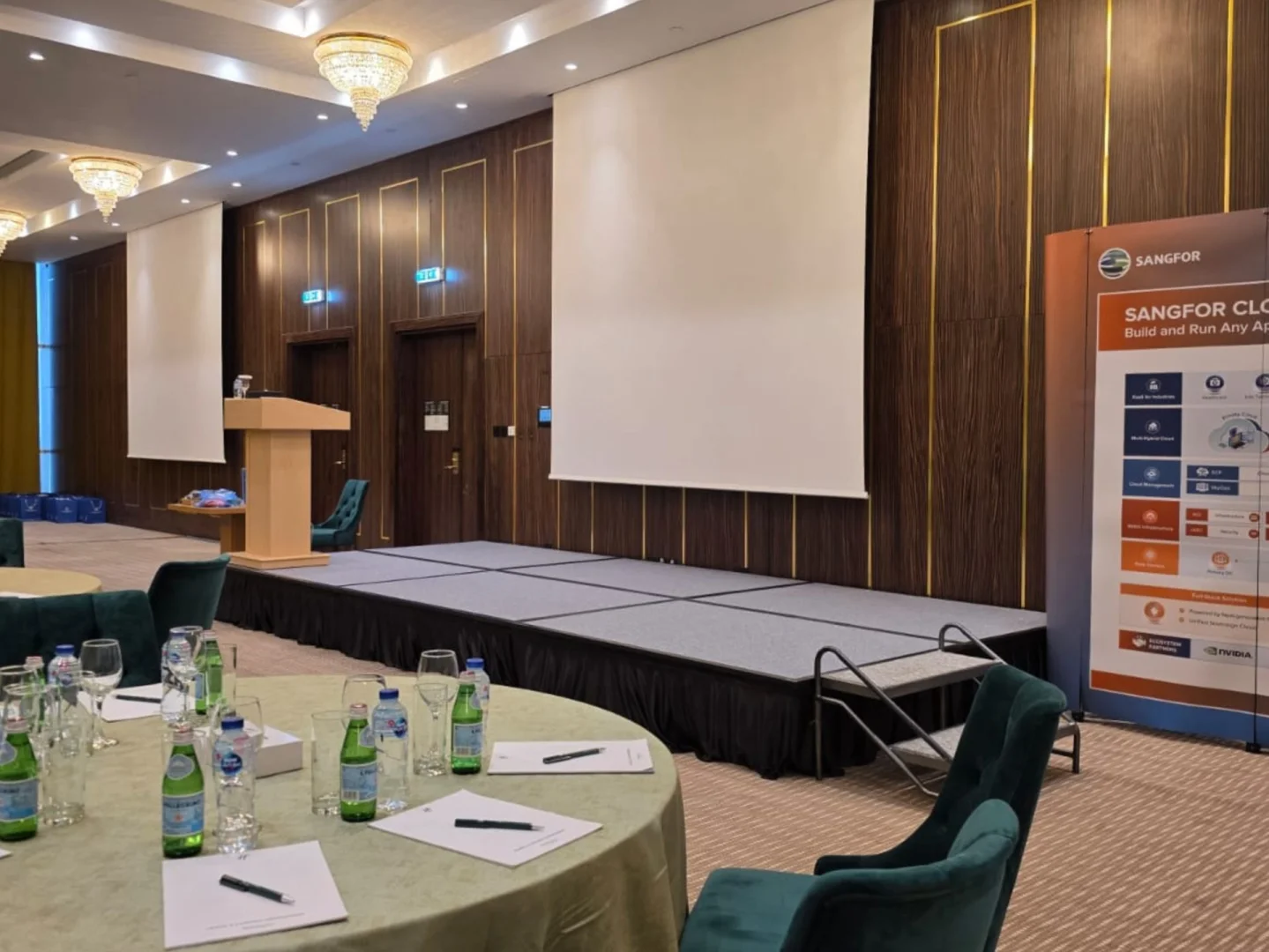 Conference setup with stage and tables at Holiday Inn Riyadh al Malaz, Riyadh.