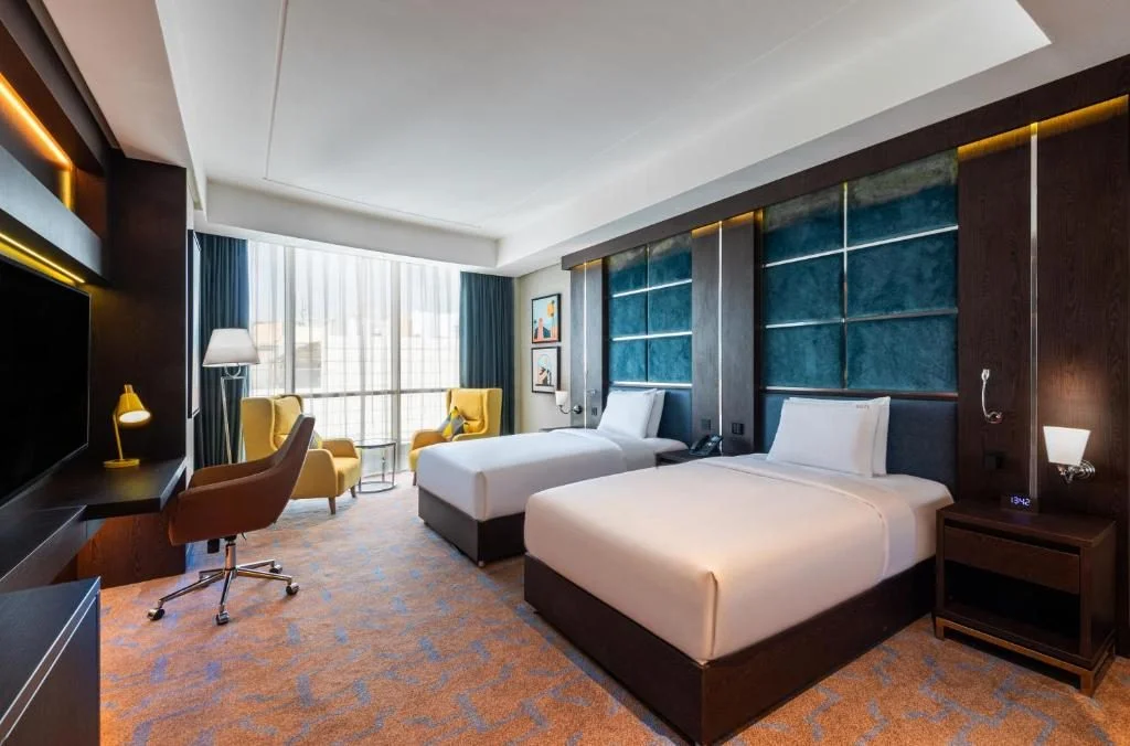 Modern guest room with twin beds at Holiday Inn Riyadh al Malaz, Riyadh.