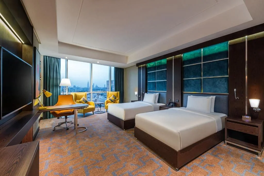 Modern guest room with two beds at Holiday Inn Riyadh al Malaz, Riyadh.