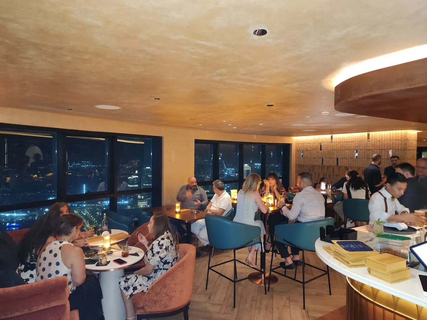 Guests enjoying evening at Observatory Lounge, Dubai, UAE with city views.