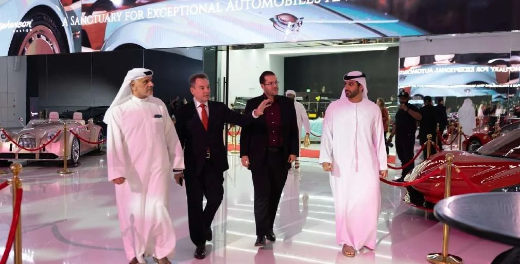 People walking in luxury car showroom at Aureum Club, Dubai, UAE