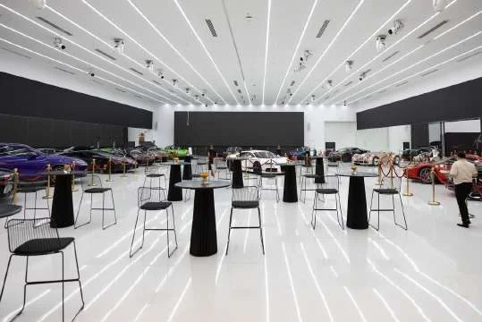 Spacious event hall with luxury cars at Aureum Club, Dubai, UAE
