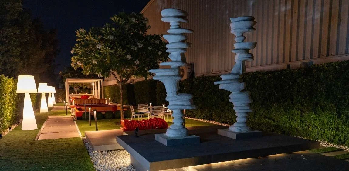 Outdoor seating and sculptures at Aureum Club, Dubai, UAE