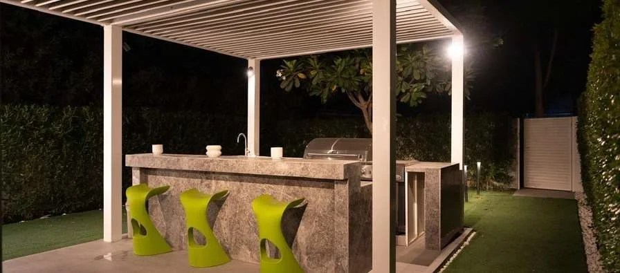 Outdoor bar area with green stools at Aureum Club, Dubai, UAE