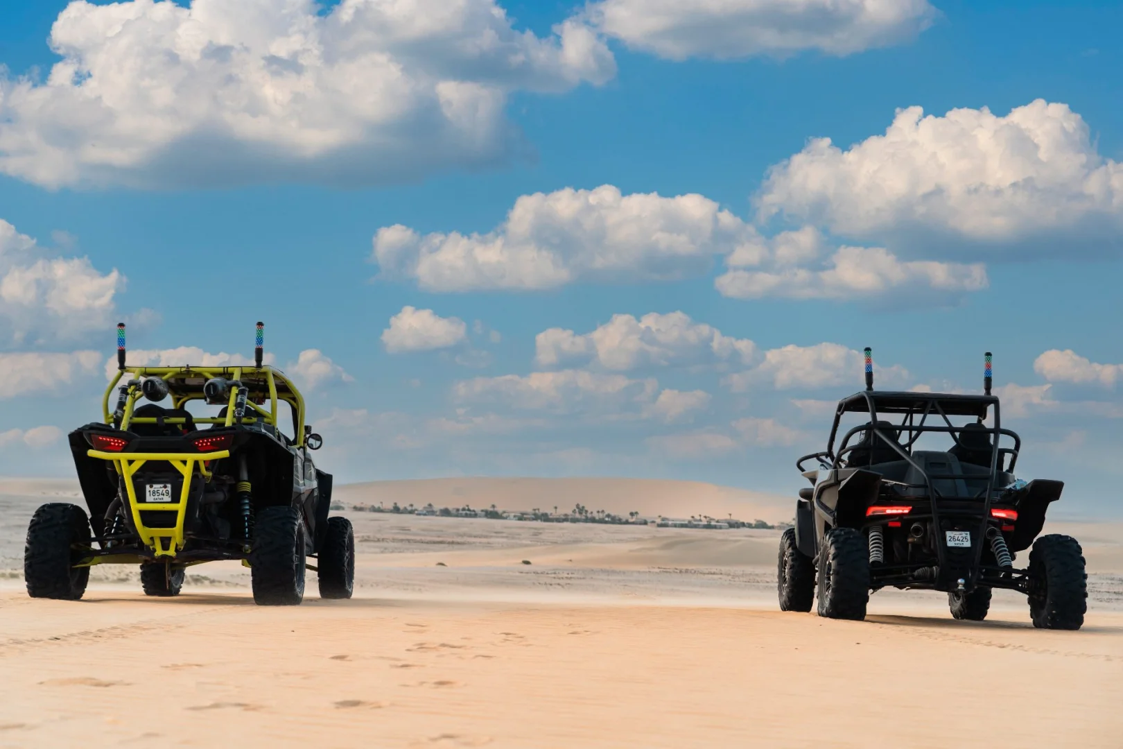 Two off-road vehicles on desert terrain at The Outpost Al Barari, Doha, QATAR.