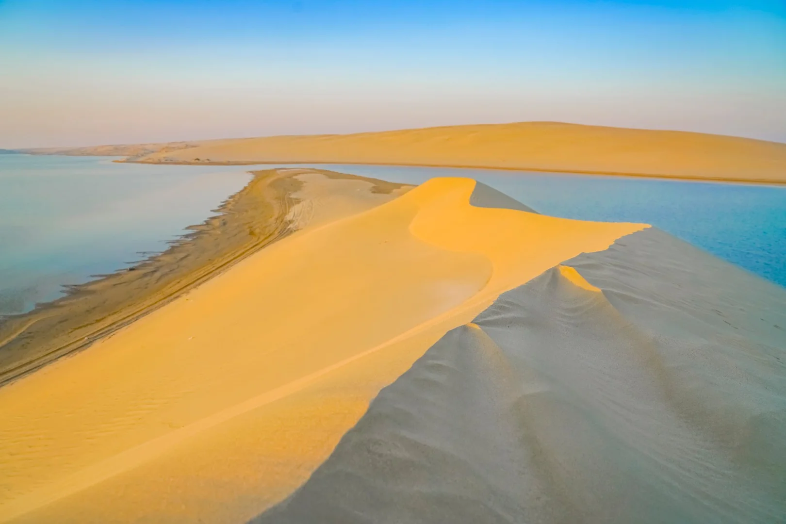 Sand dunes and water view at The Outpost Al Barari, Doha, QATAR