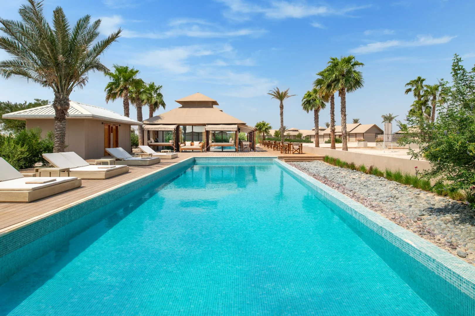 Outdoor pool and lounge area at The Outpost Al Barari, Doha, QATAR